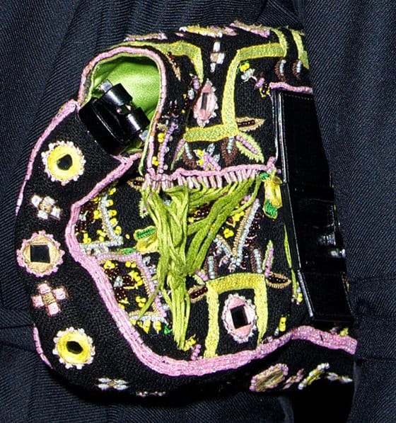 Olivia Palermo totes an embroidered clutch