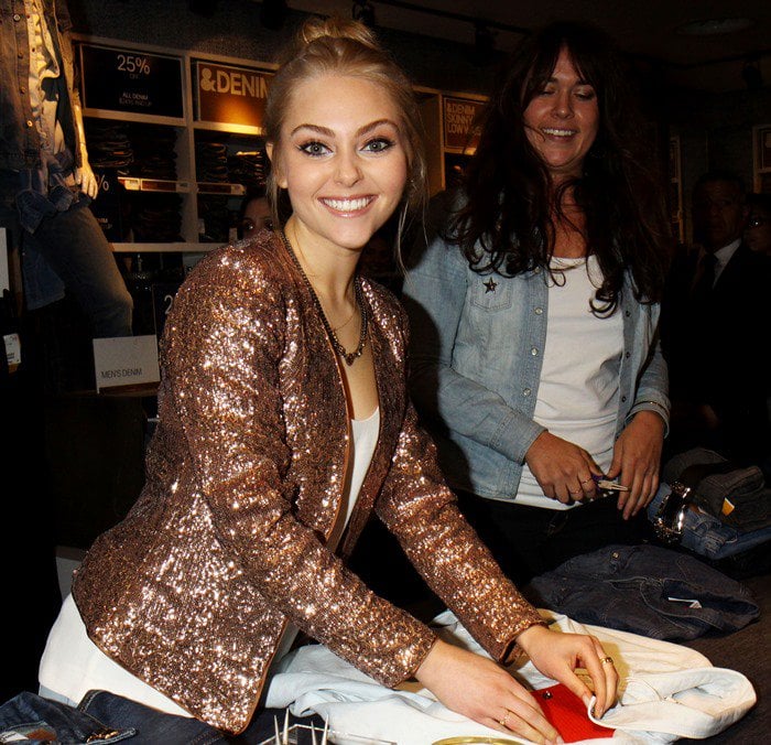 AnnaSophia Robb wears a copper-colored sequined jacket at the HM "Denim Days" event