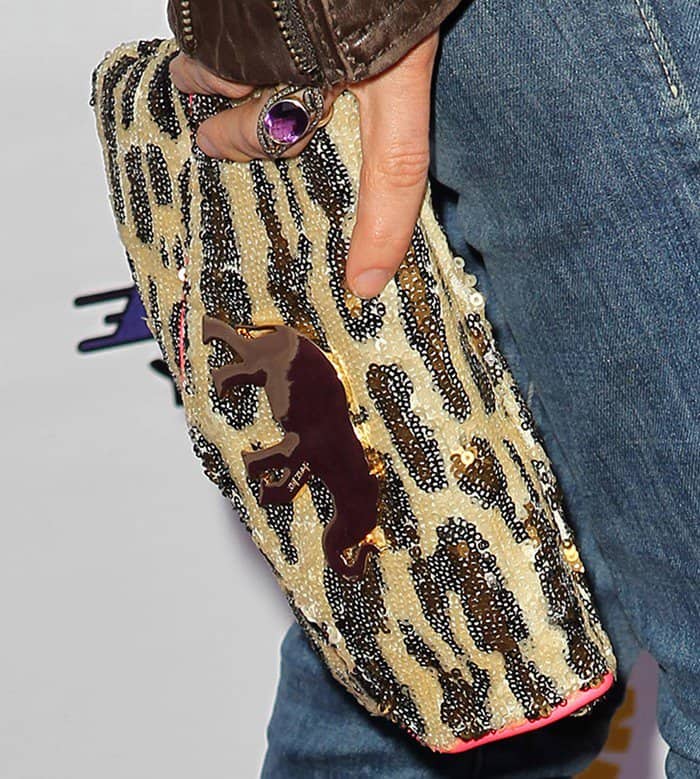 Bethany Joy Lenz's bold animal-print clutch is adorned with intricate beadwork and a statement metallic bull detail