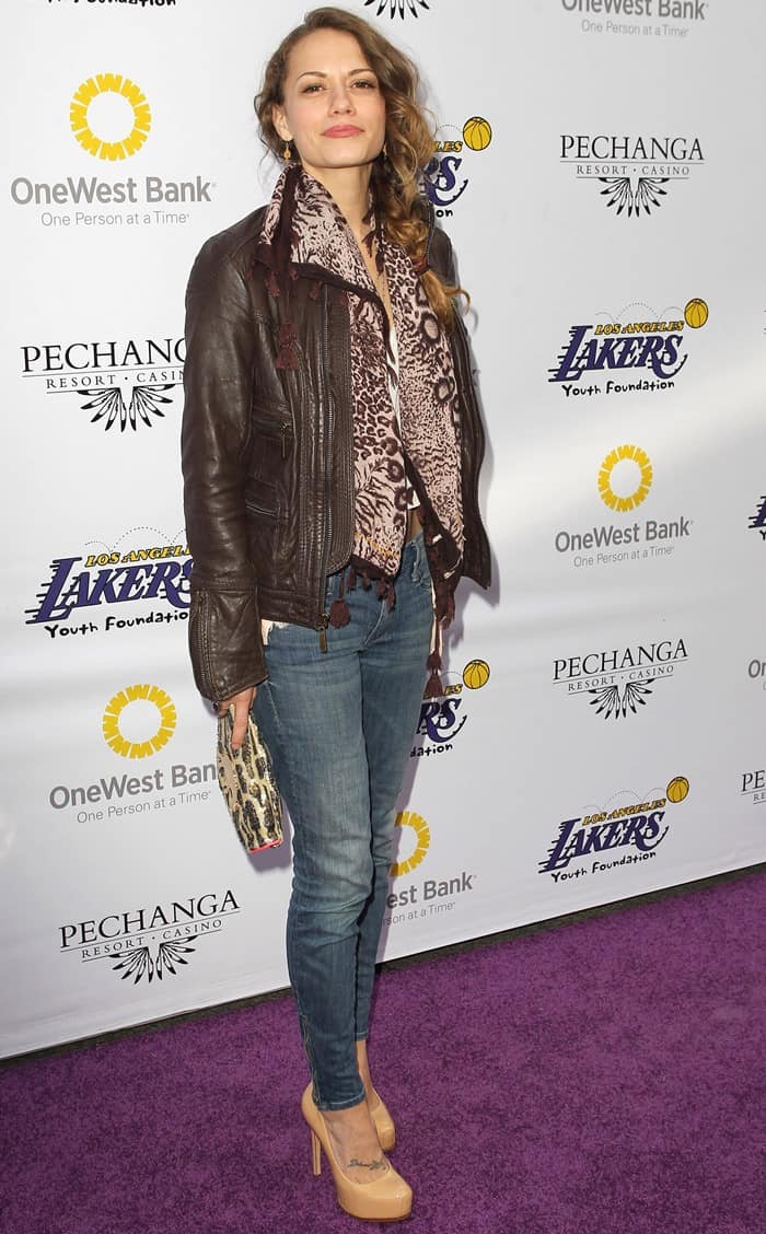 Bethany Joy Lenz pairs chic nude pumps with a leather jacket, animal print scarf, and jeans for a casual yet stylish vibe