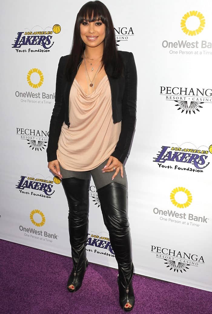 Cheryl Burke turns heads in a blush draped top, leather leggings, and edgy zippered peep-toe booties, topped off with a sleek black blazer for a bold yet sophisticated look