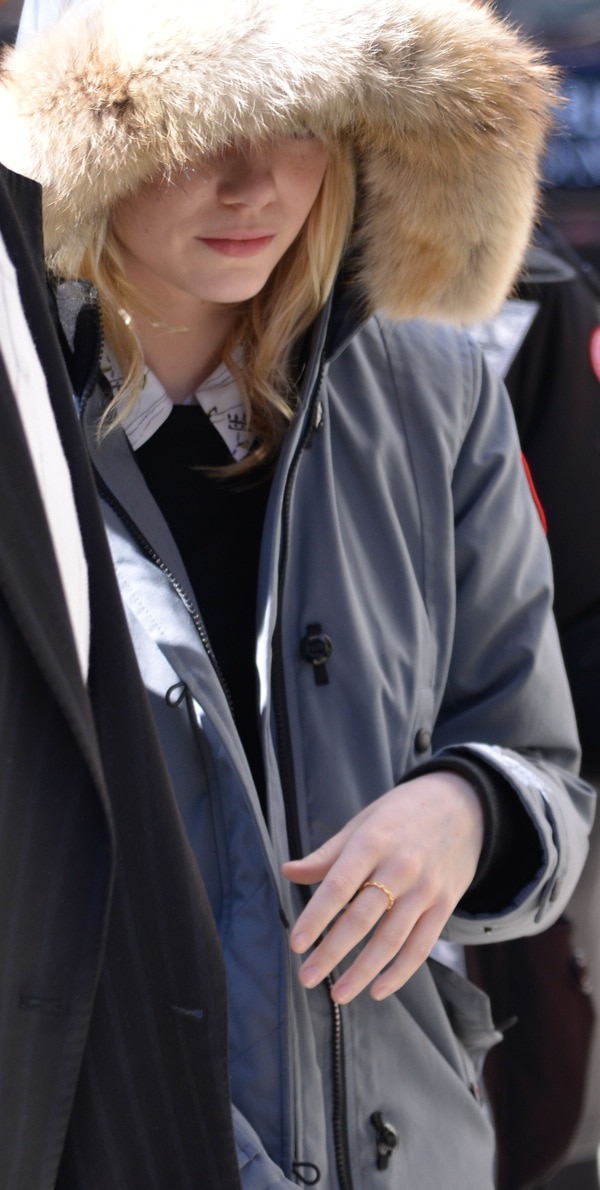 Emma Stone hides her face from photographers in a bulky Trillium down parka with genuine coyote fur trim