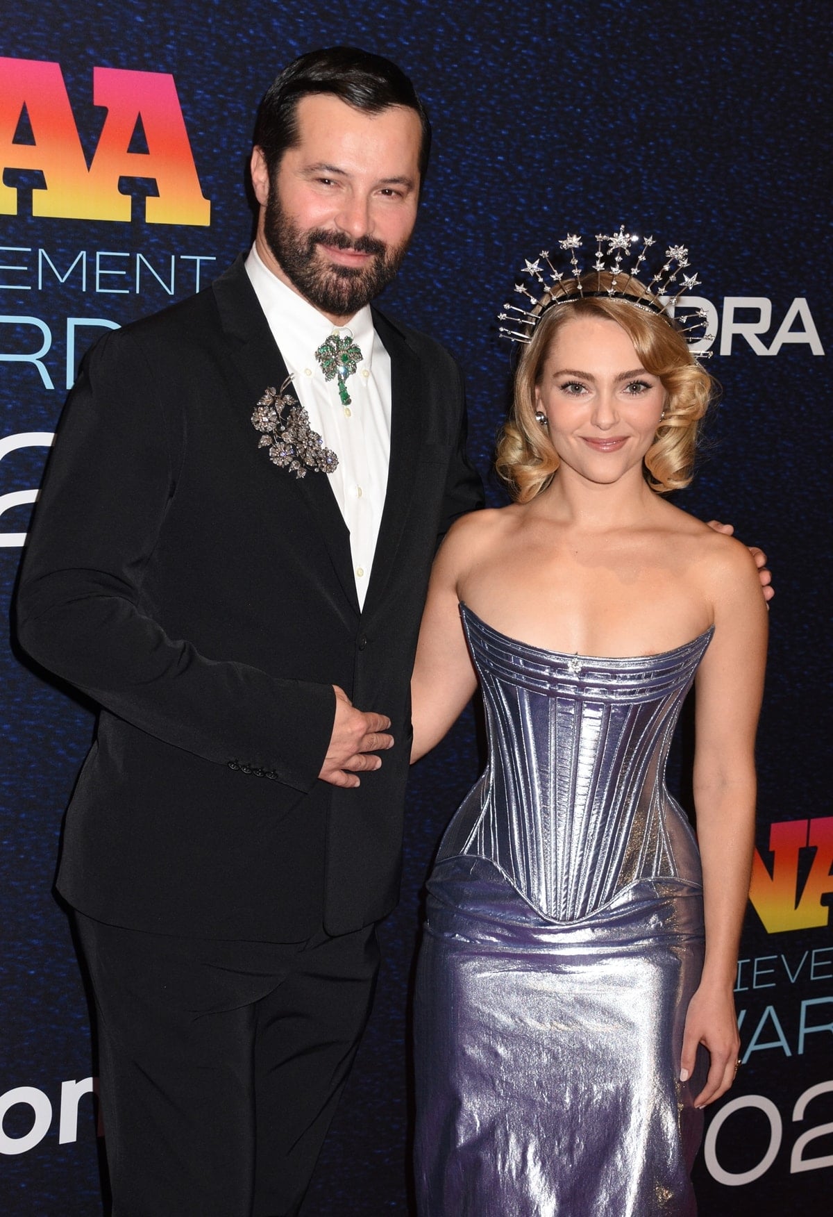 AnnaSophia Robb looks tiny standing next to Gherardo Felloni at the 37th Annual Footwear News Achievement Awards