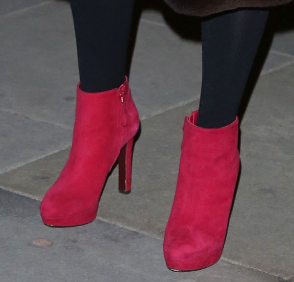 Jo Wood elevates her ensemble with these striking red suede platform ankle boots