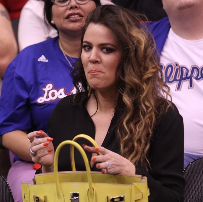 Khloé Kardashian is pictured with her iconic Hermès 35cm Candy Birkin Bag in a vibrant Lime shade