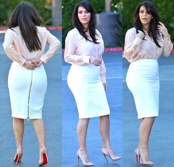 A closer look at Kim Kardashian's white high-waist pencil skirt by Tom Ford, featuring a striking gold zipper detail that runs down the back