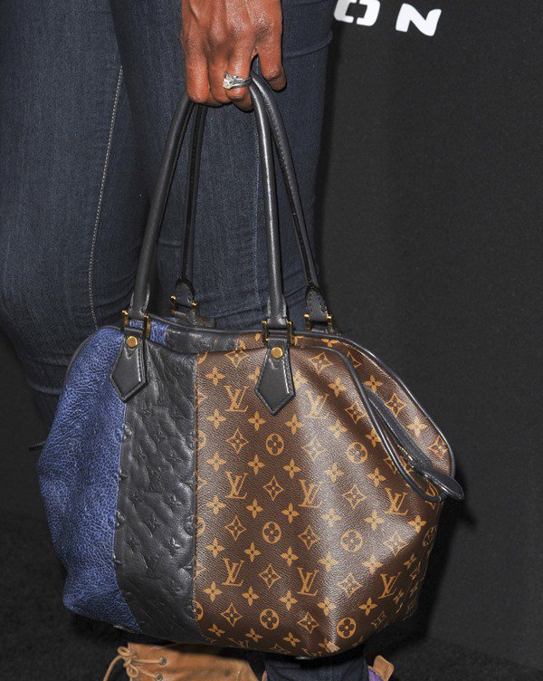 Lisa Leslie carried a Louis Vuitton bag