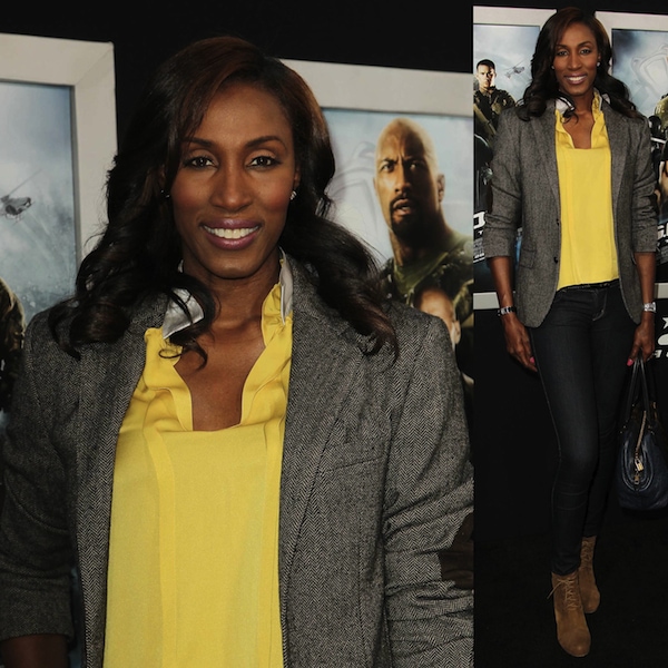 Lisa Leslie nails smart-casual chic by pairing a structured gray blazer with a vibrant yellow blouse, dark skinny jeans, and suede wedge booties for a polished yet relaxed red carpet look