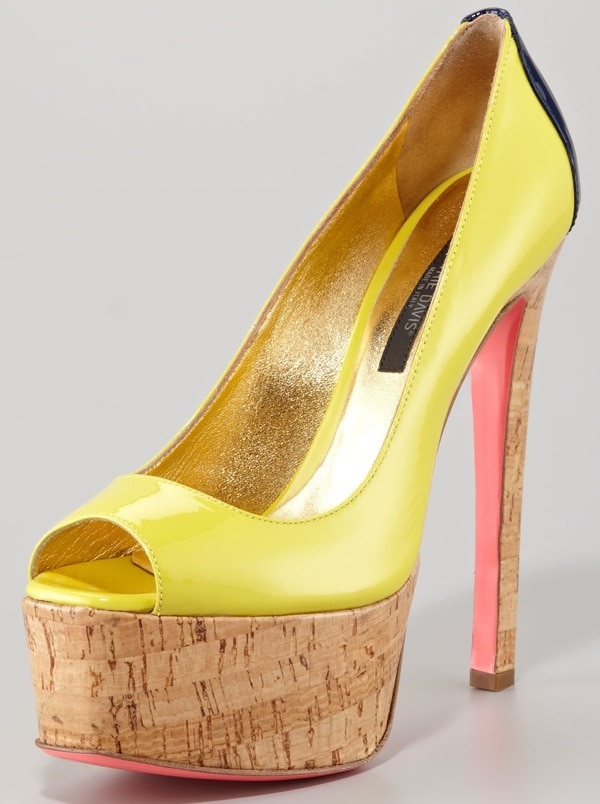 This bold Ruthie Davis pump pairs glossy lemon-yellow patent leather with a sky-high cork platform and a candy-pink sole for a vibrant, statement-making finish