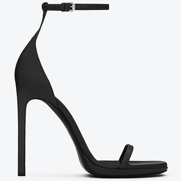 Saint Laurent “Jane” sandals feature a minimalist single-strap design with a slender ankle strap and towering stiletto heel — originally retailing for $795