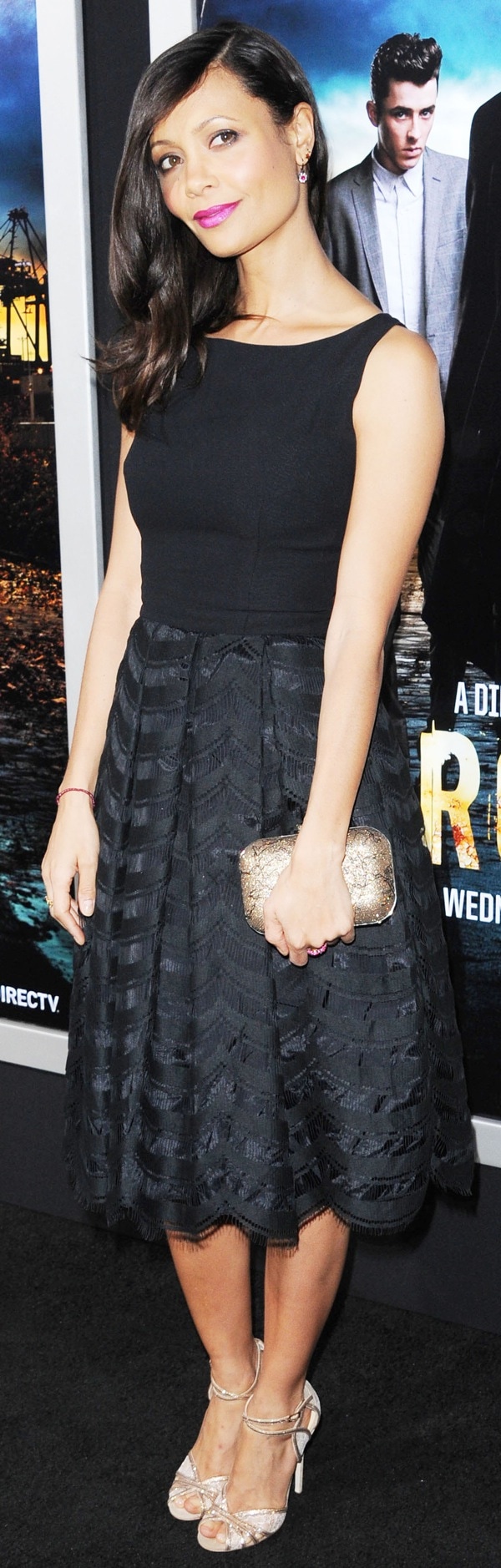 The actress radiates elegance with side-swept waves, fuchsia lips, and a sleek silhouette that highlights her vintage-inspired dress