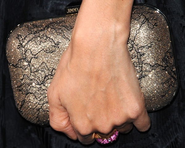 Her metallic Jimmy Choo box clutch with black lace overlay adds the perfect touch of sparkle to the monochrome look