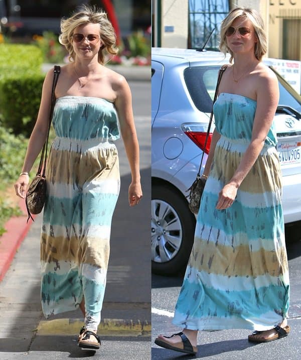 Amy Smart in Strapless Tie-Dye Maxi Dress Amy Smart exudes summer charm in a strapless tie-dye maxi dress paired with casual sandals and a stylish cross-body purse
