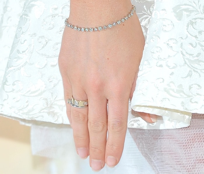 Frankie Essex keeps it effortlessly elegant with a delicate diamond bracelet and a Cartier Love ring, letting her natural, minimalist manicure complement the intricate brocade of her dress
