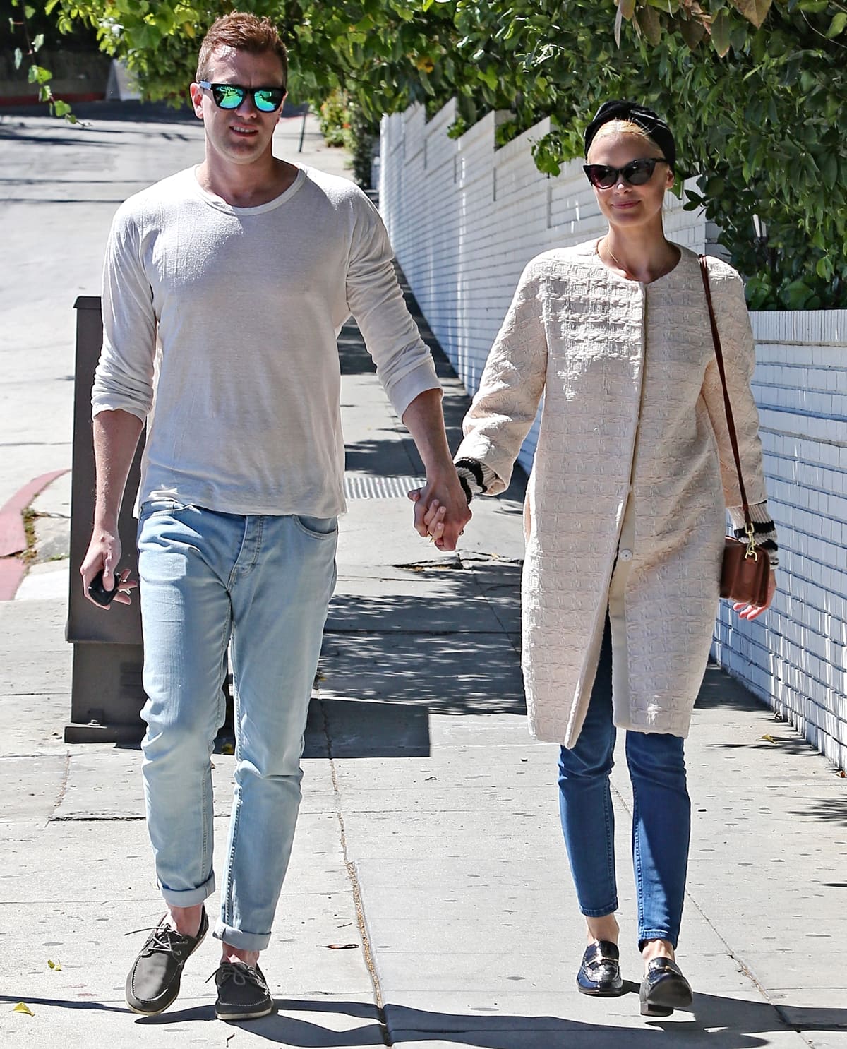 Jaime King and Kyle Newman step out hand-in-hand in West Hollywood on April 9, 2013, with their notable height difference on display—Jaime looking effortlessly chic in cropped skinny jeans, a textured cream coat, and black loafers, while Kyle keeps it casual in rolled-up jeans and a lightweight long-sleeve tee