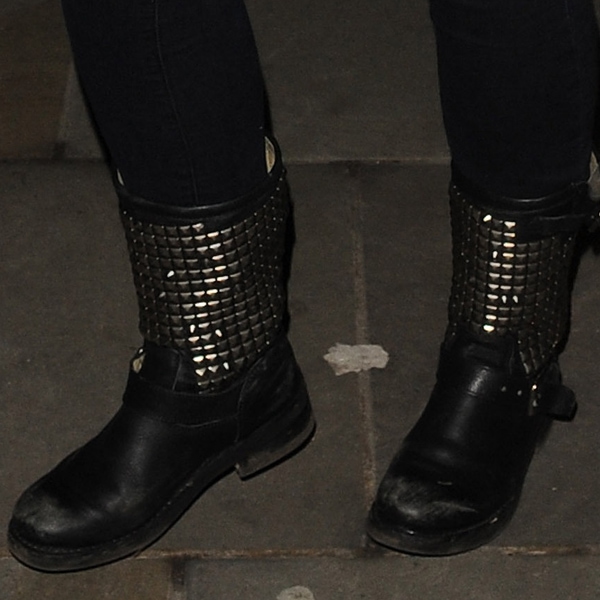 A close-up spotlights Jennifer Ellison’s black studded rain boots on March 19, 2013, adding a tough, fashion-forward edge to her off-duty theater style outside the Palace Theatre