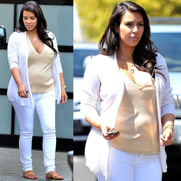 Kim Kardashian steps out for lunch at Il Pastaio in Beverly Hills on April 20, 2013, embracing effortless maternity style in a beige V-neck top, white cardigan, white skinny jeans, and tan flat sandals