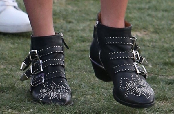 Nicky Hilton grounded her Coachella look with Chloé's iconic Susanna boots, whose studded leather construction and triple-buckle detailing helped define the bohemian-rock footwear trend of the era