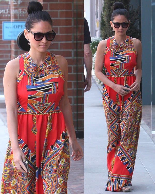 Olivia Munn brings effortless summer polish to a bold, geometric-print maxi dress, styled with oversized sunglasses, a sleek topknot, and minimal sandals that keep the focus on the statement silhouette