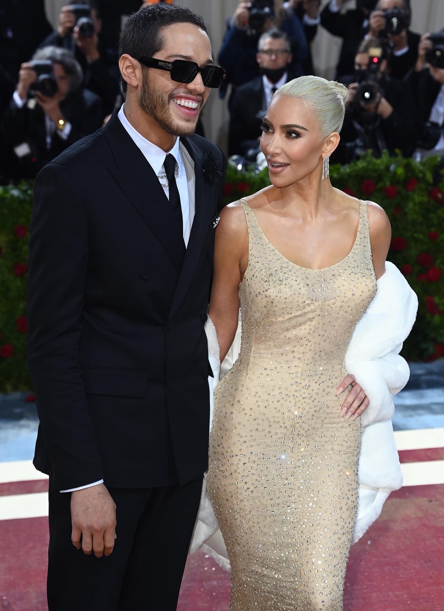 Kim Kardashian, glowing in Marilyn Monroe’s crystal-embellished gown, shares a red carpet moment with then-boyfriend Pete Davidson at the 2022 Met Gala
