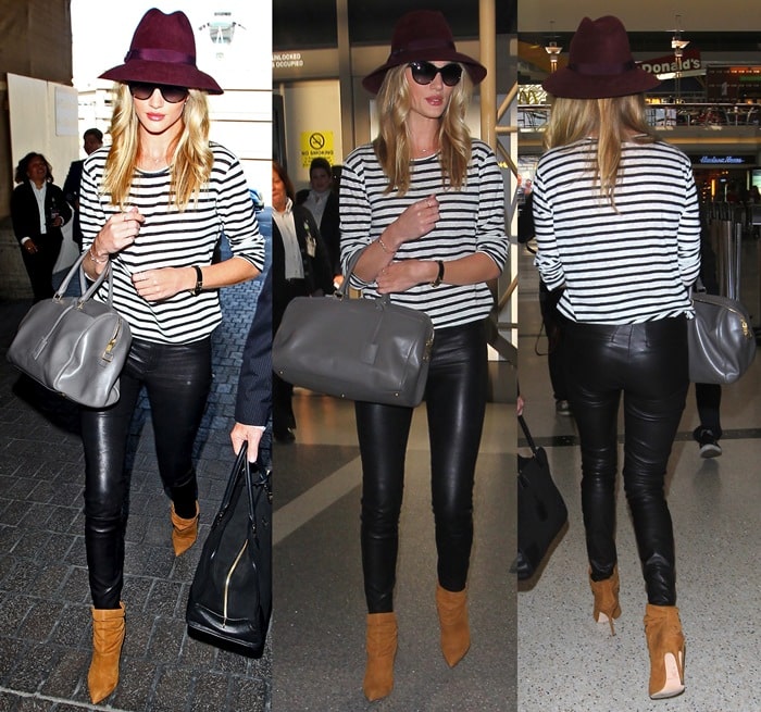 British model Rosie Huntington-Whiteley pairs tan Brian Atwood 'Adrienne' ankle boots with leather pants for a chic airport look at LAX on April 15, 2013