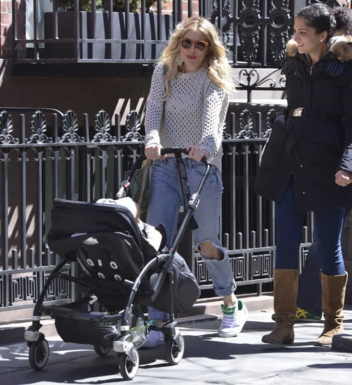 In New York City on April 6, 2013, Sienna Miller was seen wearing a Paper Denim Cloth Lexington sweater, Eze skinny slouch jeans in Ripper, and carrying a Stella McCartney python print bag