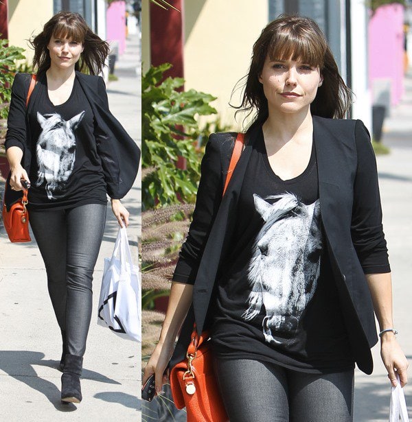 Sophia Bush runs errands in West Hollywood on April 6, 2013, pairing black suede Rag Bone Newbury ankle boots with metallic skinny jeans, a horse-print tee, a tailored blazer, and a bright red crossbody bag