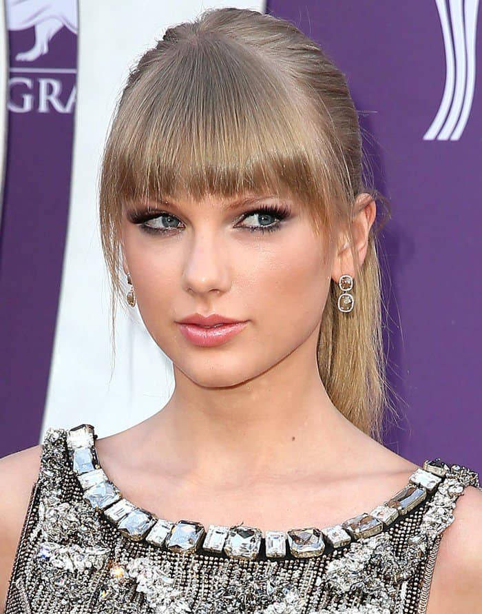 Showcasing her iconic fringe, Taylor Swift complements her Dolce  Gabbana gown with understated elegance at the ACM Awards