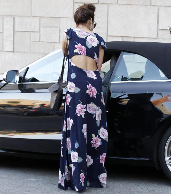 Vanessa Hudgens steps out of Nine Zero One hair salon in West Hollywood on March 27, 2013, showcasing her backless floral maxi dress and effortless boho-chic vibe