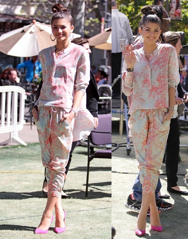 Zendaya let her youthful style shine in a coral-printed Suno jumpsuit, adding a playful pop of color with bold pink Jimmy Choo “Anouk” pumps