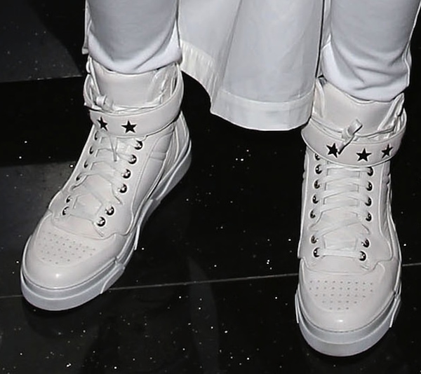 Ciara’s white Givenchy high-top sneakers feature a perforated toe box and polished leather finish, elevating the menswear-inspired look with a clean, architectural edge
