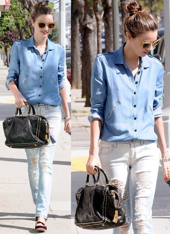 In Hollywood on April 8, 2013, Miranda Kerr sported a fashionable Prada black calfskin studded medium tote, complementing her casual chic outfit that included a Scanlan  Theodore denim shirt, Mango jeans with decorative rips, Miu Miu velvet smoking slippers, Miu Miu cat-eye sunglasses in yellow glitter, and a Rolex Oyster Perpetual Air-King watch