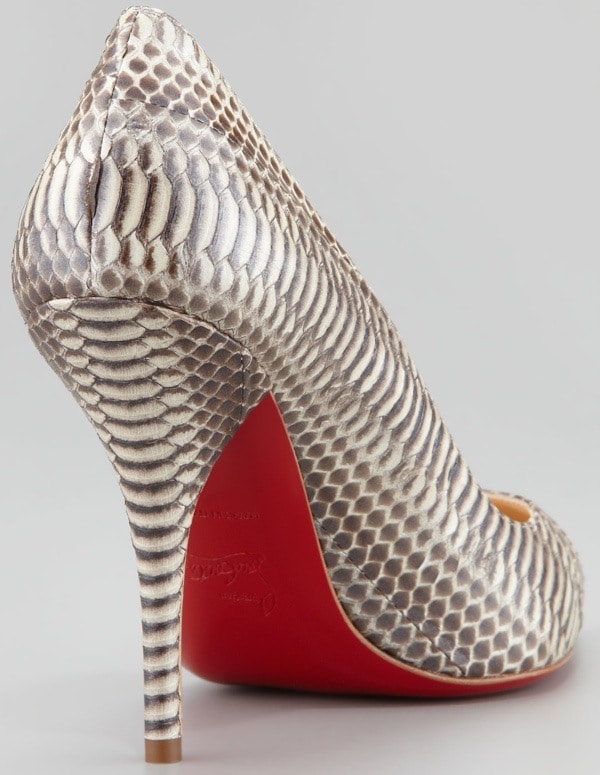 Christian Louboutin’s “Batignolles” pump showcases its striking snakeskin texture and signature red sole, blending luxury craftsmanship with bold, sculptural design