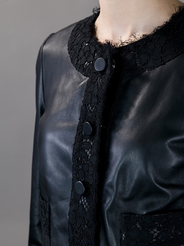 Full-length view of Dolce Gabbana’s leather and lace cropped jacket, highlighting its unique design and elegant craftsmanship