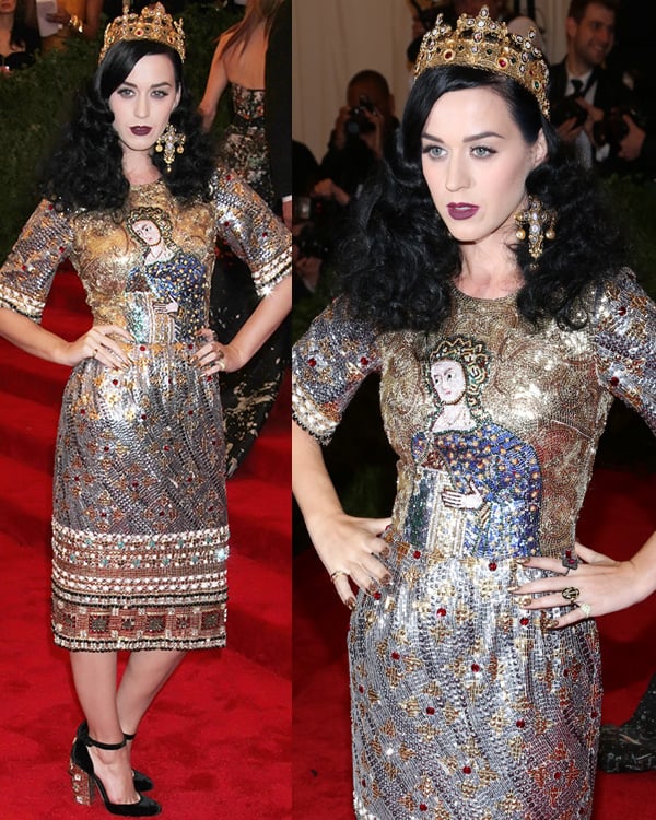 Crowned as gothic royalty, Katy Perry wore a Joan of Arc-inspired, intricately embellished Dolce Gabbana dress, complemented by elegant black ankle-strap heels, at the Met Gala