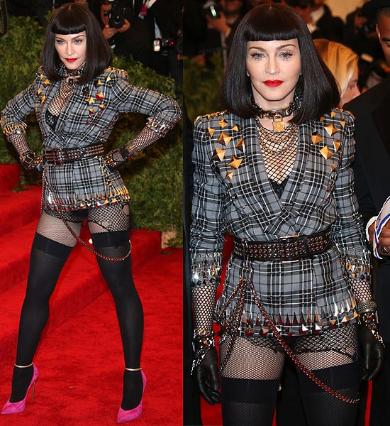Madonna commands attention at the 2013 Met Gala in a studded plaid Givenchy jacket styled with fishnet layers, leather gloves, and bold chains, finishing the punk-inspired look with striking pumps