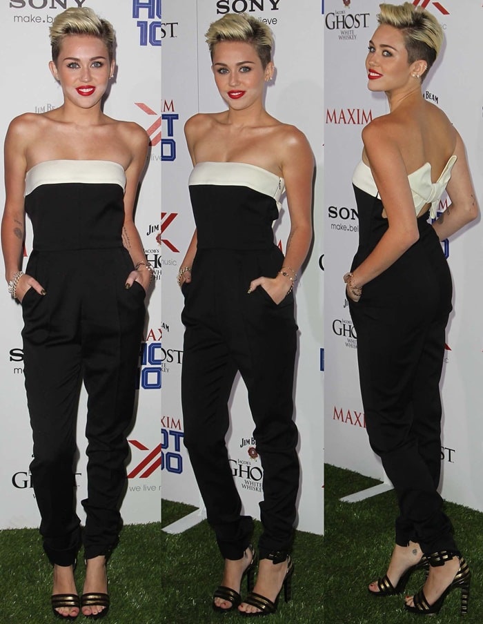 Miley Cyrus arriving at the Maxim Hot 100 Party in a sleek black strapless jumpsuit, styled with striking Saint Laurent ‘Paloma’ cuff sandals featuring black and gold stripes