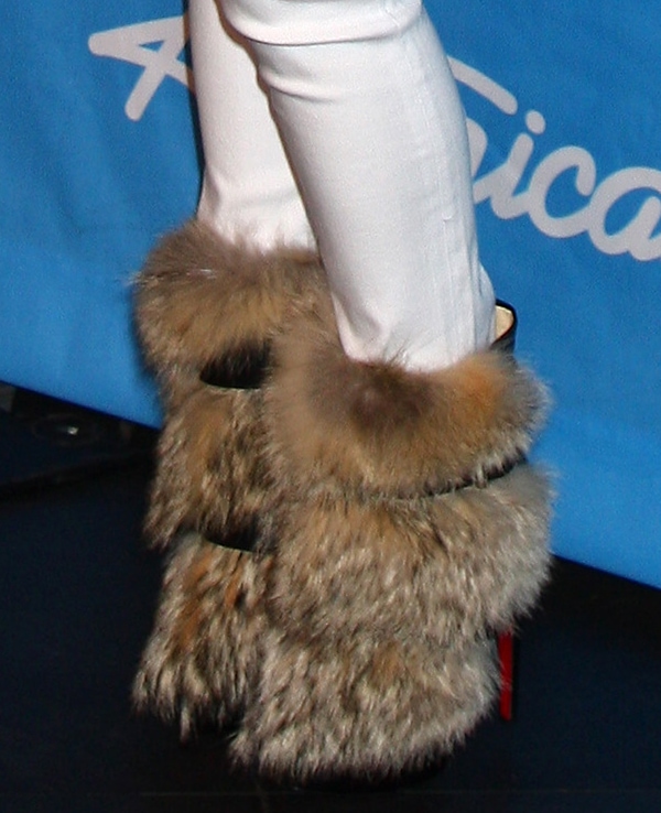 Nicki Minaj in Christian Louboutin Toundra Boots Nicki Minaj's boots feature two buckled belt straps and natural coyote fur