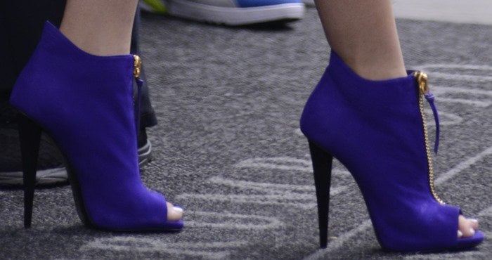 Zendaya's vibrant purple Giuseppe Zanotti peep-toe booties not only make a bold statement but also add significant height with their sleek stiletto heels