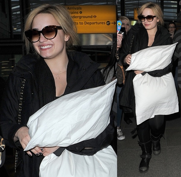 Demi Lovato clutching a large pillow