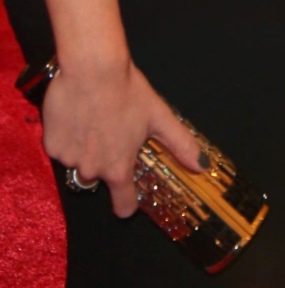 Emily Blunt paired her refined look with a gold barrel clutch