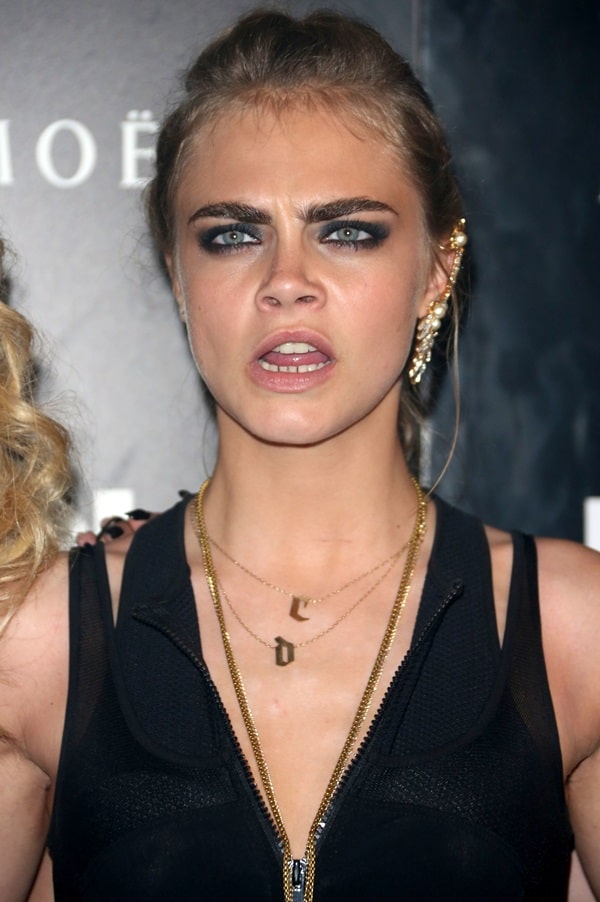 Cara Delevingne captivates with her playful side at the DKNY Artworks launch party in London