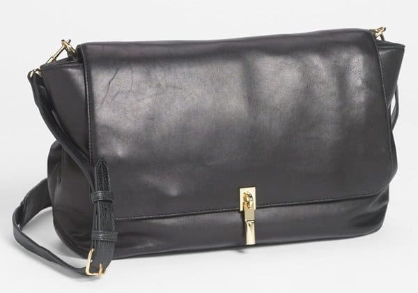 Detailed view of the Elizabeth and James Leather Crossbody Bag, featuring smooth leather with lizard-embossed details and gold-tone hardware