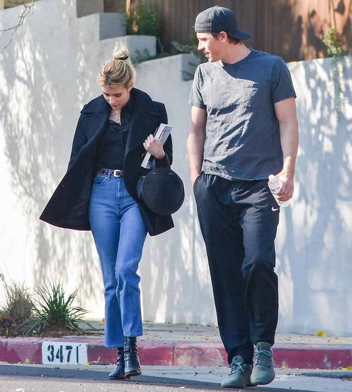 Emma Roberts keeps her date-day look sharp and understated in high-waisted cropped jeans and sleek black lace-up ankle boots, adding a polished edge to her relaxed Los Angeles stroll with Garrett Hedlund on January 12, 2020