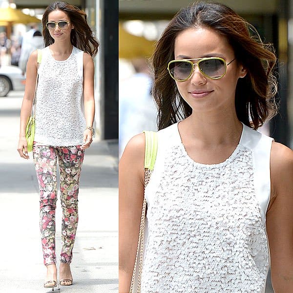 Jamie Chung refines daytime polish in Beverly Hills, pairing rose-gold metallic sandals with moody floral David Kahn “Nikki” ankle jeans and a breezy white sleeveless top, while neon accents and aviator sunglasses add a sunlit California finish