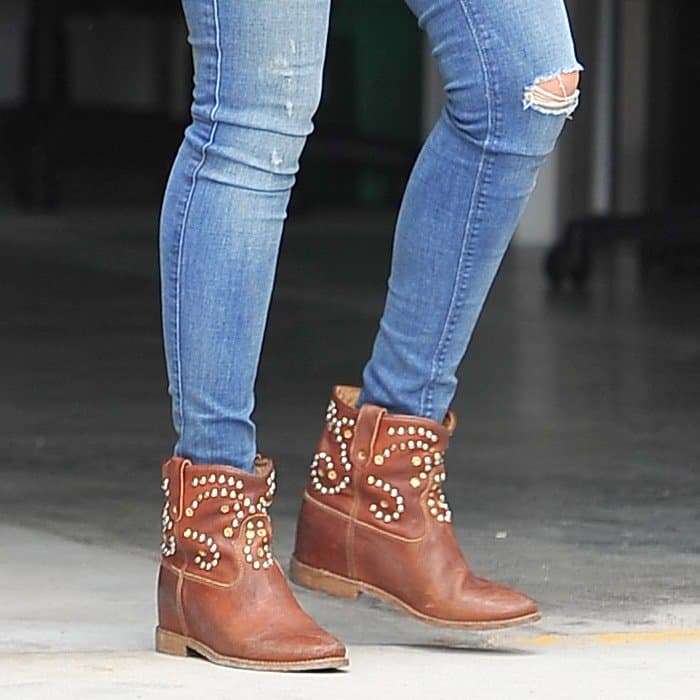 Jessica Alba steps out in distressed denim and Isabel Marant's Caleen studded ankle boots, showcasing the perfect blend of casual chic and Western flair