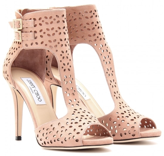 Rendered in soft blush suede, the Jimmy Choo “Malika” booties showcase delicate laser-cut detailing and a lighter, more feminine take on the architectural design