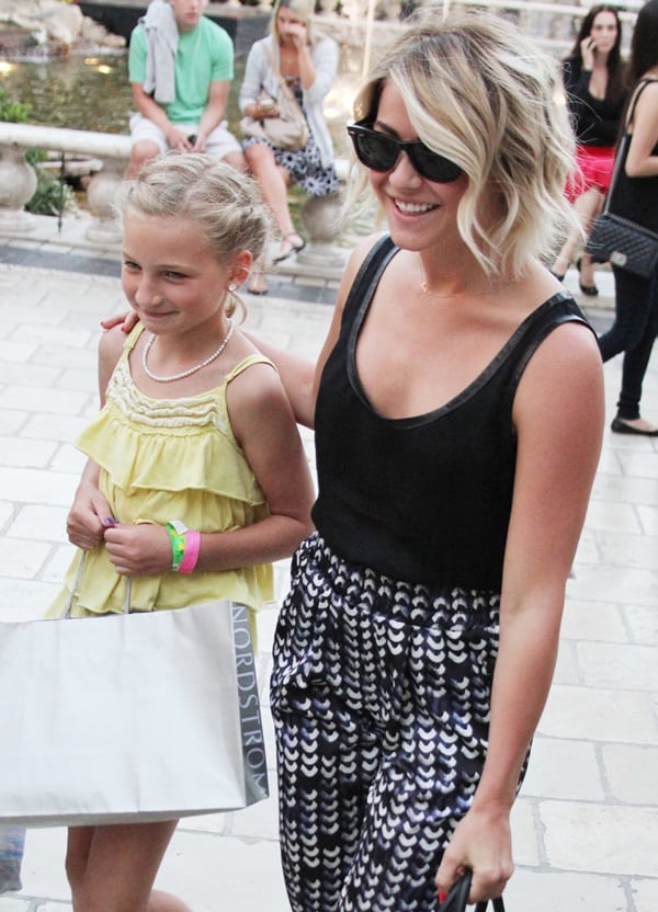 Julianne Hough wearing printed slouchy pants with a black tank top