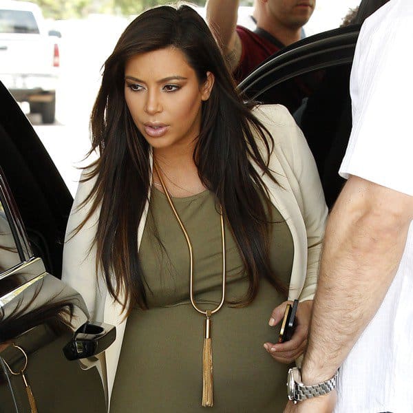 Close-Up of Kim Kardashian's Saint Laurent 'Opium' tassel necklace: An intricate piece featuring a thick tubular snake chain and long gold-tone tassel