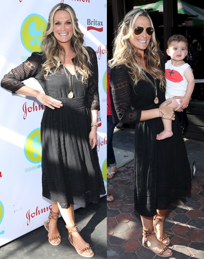 Molly Sims attends the 2013 Baby Buggy Bedtime Bash in New York, wearing a black lace midi dress paired with Isabel Marant "Caroll Elvis" studded sandals while carrying her son Brooks
